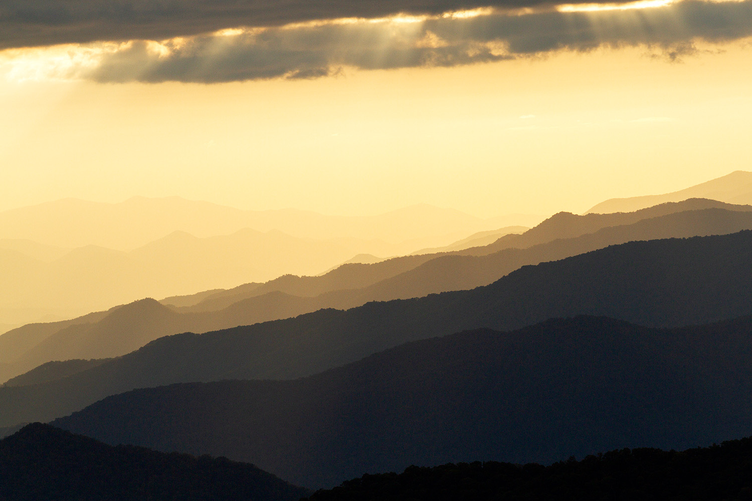 The Smoky Mountains, as seen from the Blue Ridge Parkway in North Carolina, are basked in golden light just before sunset on Sept. 30, 2023.