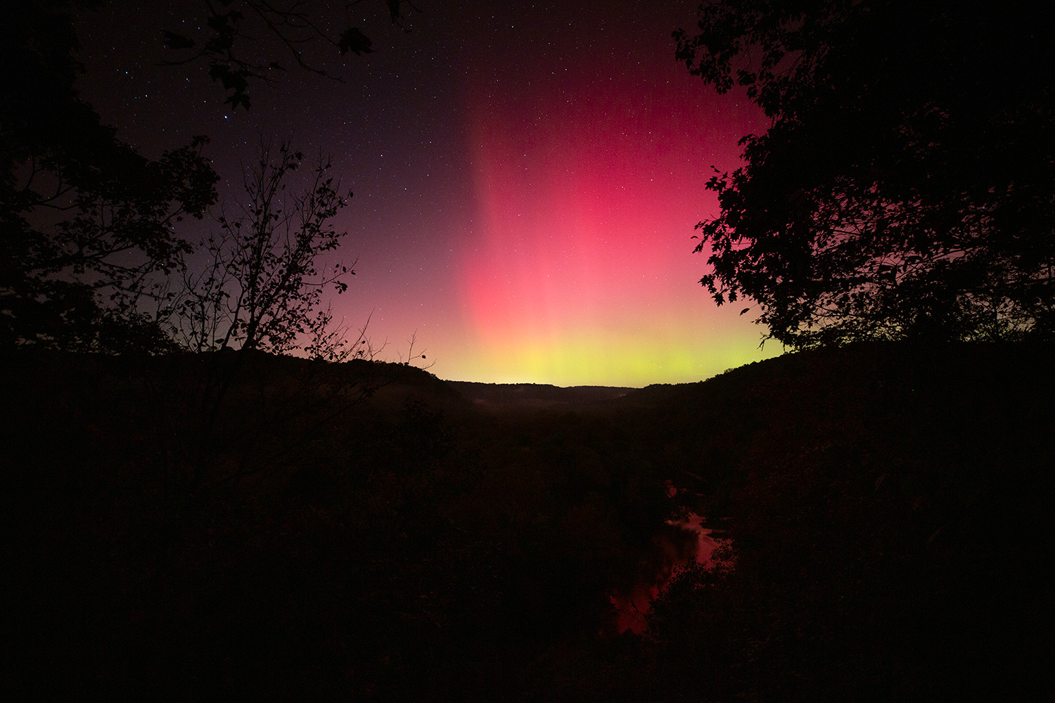 The aurora borealis, or Northern Lights, fill the sky above the Green River at Mammoth Cave National Park in Kentucky on Oct. 10, 2024.